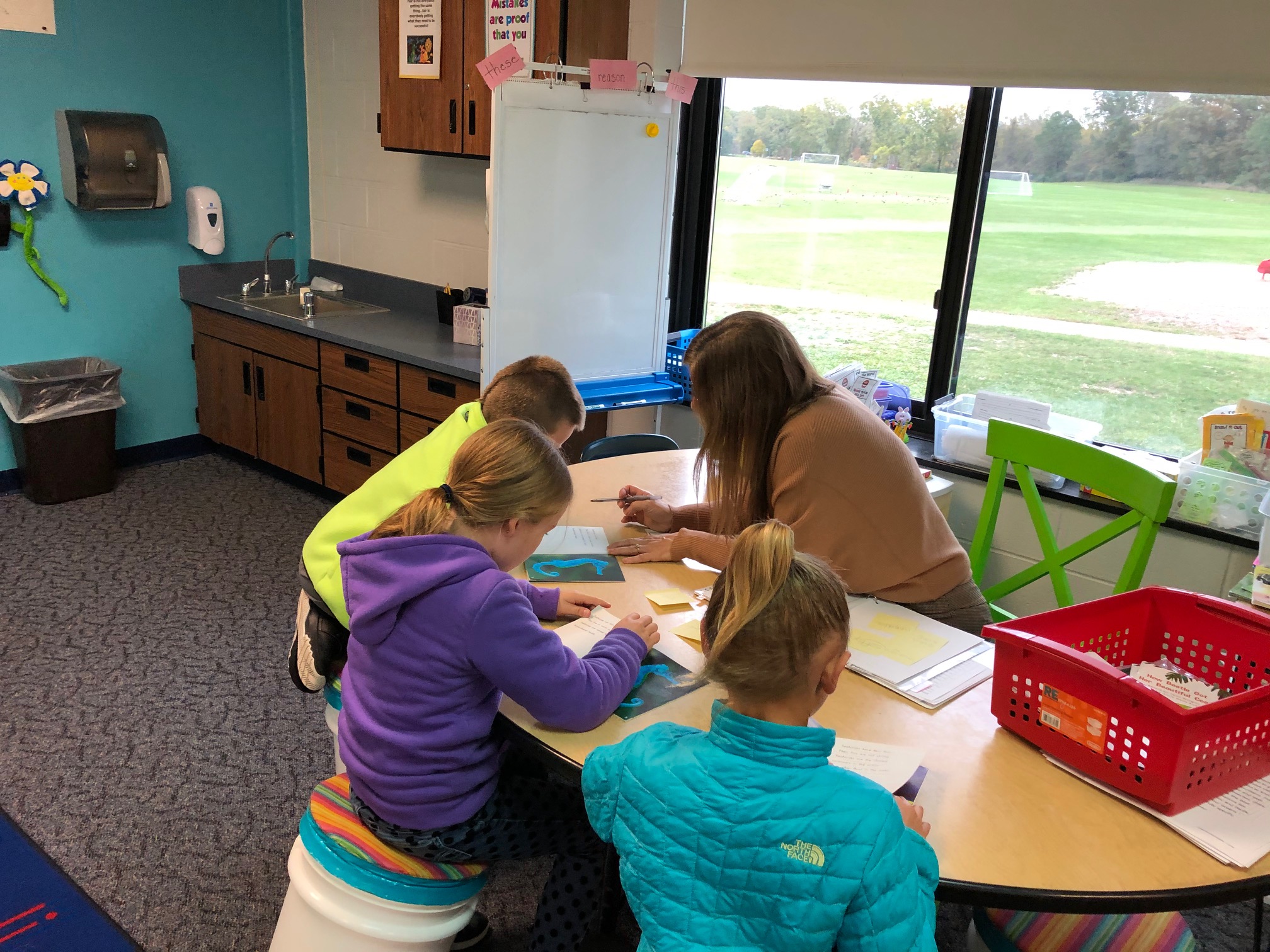 Students gathered in small group with teacher